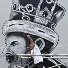 Dunedin artist Bruce Mahalski does his best Freddie Mercury impression in front of his Queen St...