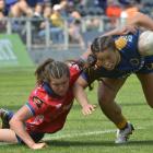 Tasman blindside flanker Tamara Silsock tries to drag down Otago second five-eighth Teilah...