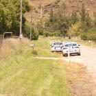 Two police cars parked up outside Toi Toi Orchards, near Alexandra, yesterday. PHOTO: ADAM BURNS
