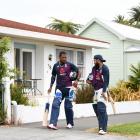 England players Chris Jordan (left) and Adil Rashid walk along the street outside McLean Parkin...