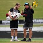 New Zealand captain Kane Williamson speaks with groundsman Karl Johnson during a nets session at...