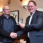 LandSAR veteran Dave Stevenson (left) is given an excellence award by national chairman Dave...