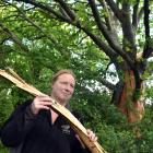 Shelli Mears holds a piece of a 100-year-old oak tree on her Palmerston farm that was hit in a...