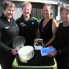 Looking over a new community worm farm facility in Clyde are (from left) Bike It Now co-owners...