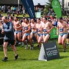 Wakatipu Rugby Club players cross the line at the Queenstown International Marathon on Saturday....
