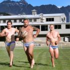 Wakatipu Rugby Club players (from left) Tom Ellis, Rhys Kearton and Logan Beggs stretch their...