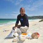 Our Seas Our Future founder Noel Jhinku collects litter at St Kilda Beach yesterday. PHOTO:...