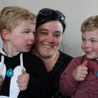 Dunedin Mum Luisa Hakai is grateful for the security offered through the WandaTrak pendants worn...