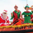 Ho! Ho! Ho! Santa Claus Paul Potter, Gaylyn Potter and elves Clark (8) and Angus (10) Manson in...