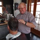 Oamaru hairdresser Ali Brosnan cuts Steve McLeod’s hair yesterday on the 50th anniversary of the...