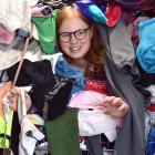 Among a large pile of clothes waiting to be sorted is Shop on Carroll retail assistant Sophia...