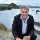 Enterprise Dunedin business relationship manager Des Adamson crouches near the Port Chalmers...
