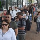 Cruise ship passengers board shuttle buses in the Octagon to get back to their ship. PHOTO:...