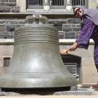 University of Otago Muslim chaplain Salmah Kassim rings the bell to mark handing in her PhD...