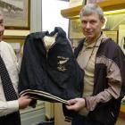 New Zealand Sports Hall of Fame chief executive Ron Palenski (left) accepts the tracksuit top...