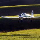 A topdressing plane applies a load of fertiliser on to a Central Otago property. PHOTO: STEPHEN...