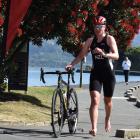 Cecilia Crooks heads for transition following the 20km cycle stage on her way to winning the open...