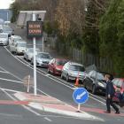 A father and child cross Brown St in Dunedin on one of the city’s new courtesy crossings inside...