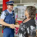 Constable Rick Groen, who is one of five police patrolling Hoon Hay more often, talking to Debbie...