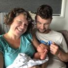 Arriving a little later than expected is Fergus James Glasgow, pictured with proud parents Kate...
