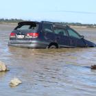 A car with a smashed rear window was found half submerged in an Invercargill estuary yesterday....