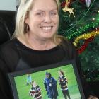Melissa Vining holds one of her favourite photos of her late husband Blair and daughters Lilly ...