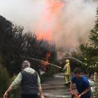 Firefighters and locals battle a large blaze in Warrington on Saturday. PHOTOS: ANDREW MORRISON