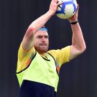 Otago top order batsman Nick Kelly warms up with a game of football during a training session at...