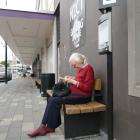 Gisela Andrew, of Dunedin, waits for her bus at the Great King St hub on Tuesday. PHOTO: JESSICA...