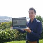Dunedin City Council policy analyst Junichi Sugishita holds a laptop showing the new interactive...
