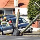 A car hit a power pole on Taieri Rd about midday. Photo: Peter McIntosh