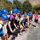 Competitors get ready to head into the water at the start of the Under-14 girls race at lake...