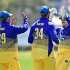 Otago Volts players (from left) Josh Finnie, Matthew Bacon and Mitch Renwick celebrate the wicket...