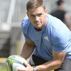 Highlanders halfback Kayne Hammington looks to move the ball at training at Logan Park yesterday....
