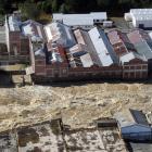 The flooded Mataura River rips past the former Mataura paper mill. Photo: Stephen Jaquiery