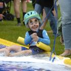 Elijah Mirkin (3), of Dunedin, zooms down the waterslide towards the finish line at the annual...