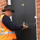 City custodian Peter Moroney delivers a Dunedin City Council Welcome To Your Flat pack, which...