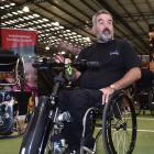 Melrose sales manager Chris Hanley shows off a wheelchair power add-on   at the Show Your Ability...