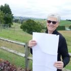 Century Farms chairwoman Karen Roughan holds up the list of applicants for this year’s award...
