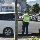 Senior Constable Logan Dickie talks to occupants of a car on Cumberland St yesterday as part of a...