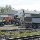 Emergency services arrive at the site of a collision between a train and truck near the...