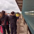 North Otago dairy farmer Jason Hayman (in yellow) shows the school pupils his feed pad. Photos:...