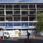 Contractors have started installing a replica coloured glass facade on the University of Otago’s...