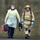 Career Firefighters Mat Loughney (left) wears personal protective equipment and Jules Bennett...