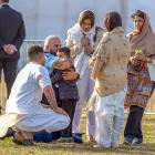 Huata Arahanga hugs five-year-old Ayaan Naeem, who lost his father and brother in the massacre on...