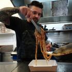 Pablo Tacchini, owner of Cucina in Oamaru, dishes up a takeaway meal yesterday. PHOTO: DANIEL...