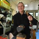 Paul Ayers repairs footwear in his Stuart St premises before making home deliveries to customers....