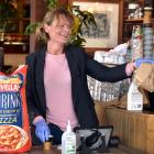 The Esplanade maitre d’ Bridget Craig, of Dunedin, hands out fresh vegetables as it seeks to get...