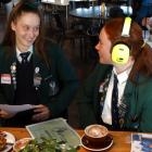 Columba College prefects Hannah Clarke (17, at left) and Isobel Fraser (16) try to communicate...
