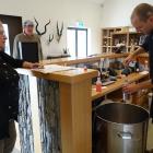 Cardrona Distillery ambassador Sam Bickley pours free alcohol hand sanitiser into a container for...